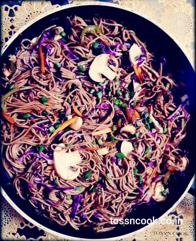 Image of Soba Noodles being prepared in the pan with exotic veggies