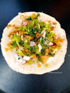 Sprinkle some masala on uttapam we prepared and add veggies