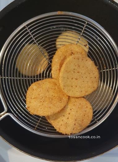 Fried Papdi on a oil strainer